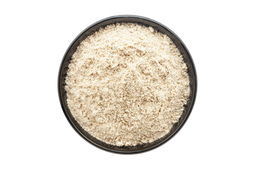 Organic Multi-Grain Flour, in a black ceramic bowl. Isolated on a white background. Top View
