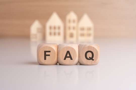 Cubes with message FAQ surrounded by wood home. Quesiton and answer about housing problems
