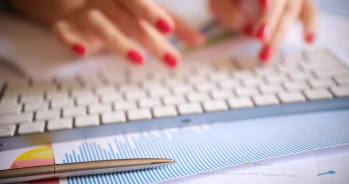 Transcriber typing on computer keyboard near graphics and pen closeup 4k movie. Transcription translate speech into text concept