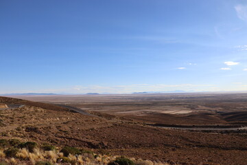 Bolivia route nr 5 and the edge of the Antiplano (high plain) where you can see in the distance Uyuni and the Uyuni salt flats.