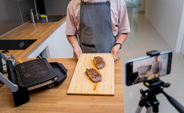 The chef is broadcasting live from workshop how to prepare a beef steaks on the electric grill