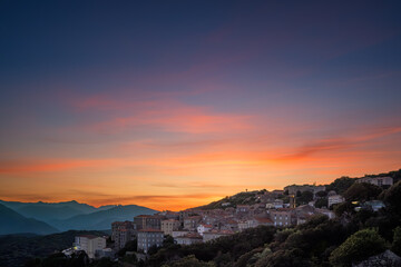 Dawn breasking over the town of Sartène in southern Corsica with the Bavella mountains in the distance