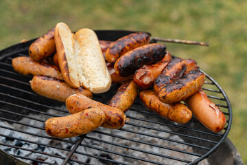 Sausages grilling on an outdoor barbecue
