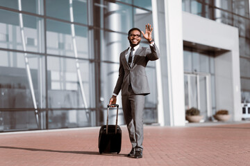 Arriving at Airport. Businessman Waving a Taxi Cab In Public Transportation Station