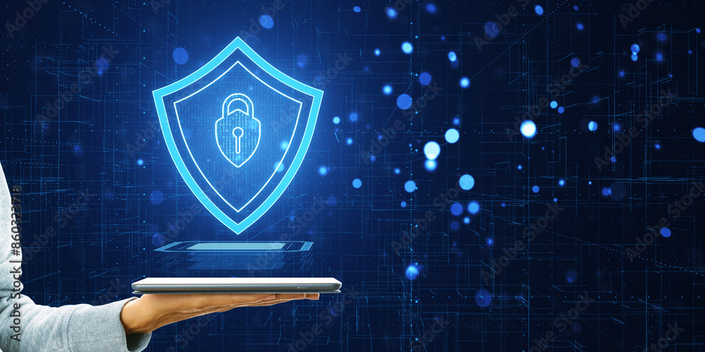 Poster a digital cybersecurity shield floating above a tablet, held by a person against a circuitry backgro