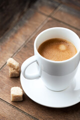 Cup of coffee on wooden background. Close up.