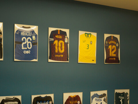 Collection of famous soccer t shirts hanging on blue wall