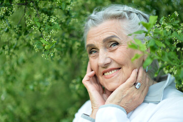 Portrait of a beautiful woman in the park in summer