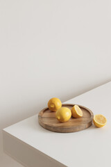 Beautiful still life with lemons on the wooden tray in minimalism. Healthy lifestyle concept.