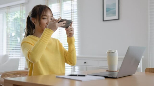 Young adult asia people Gen z girl relax WFH take selfie photo snap shot chat show share using snapchat app post viral send video vlog IG reels story instagram. Fun joy woman happy hybrid work at home