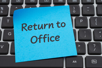 Return to office on blue sticky note on a computer keyboard