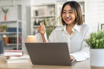 Young smiling asian woman happy relax use laptop conference work,learning, education, shopping, study online, webinar, online marketing, business, blog, digital internet advertising at home