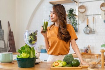 Portrait of beauty healthy asian woman making green vegetables detox cleanse and green fruit...