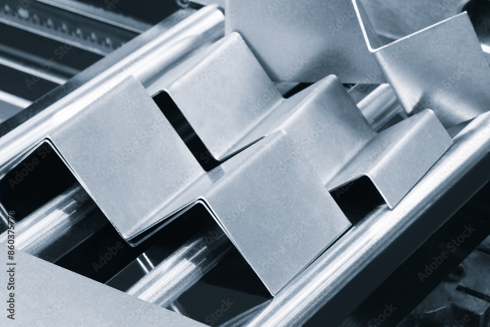 Poster a series of metal pieces are arranged in a row, with some of them being triangular. concept of preci
