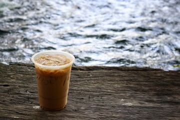 Iced coffee on brown wood background