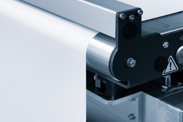 Automatic polyethylene plastic bag production machine with lighting effect. Close-up of the roller...