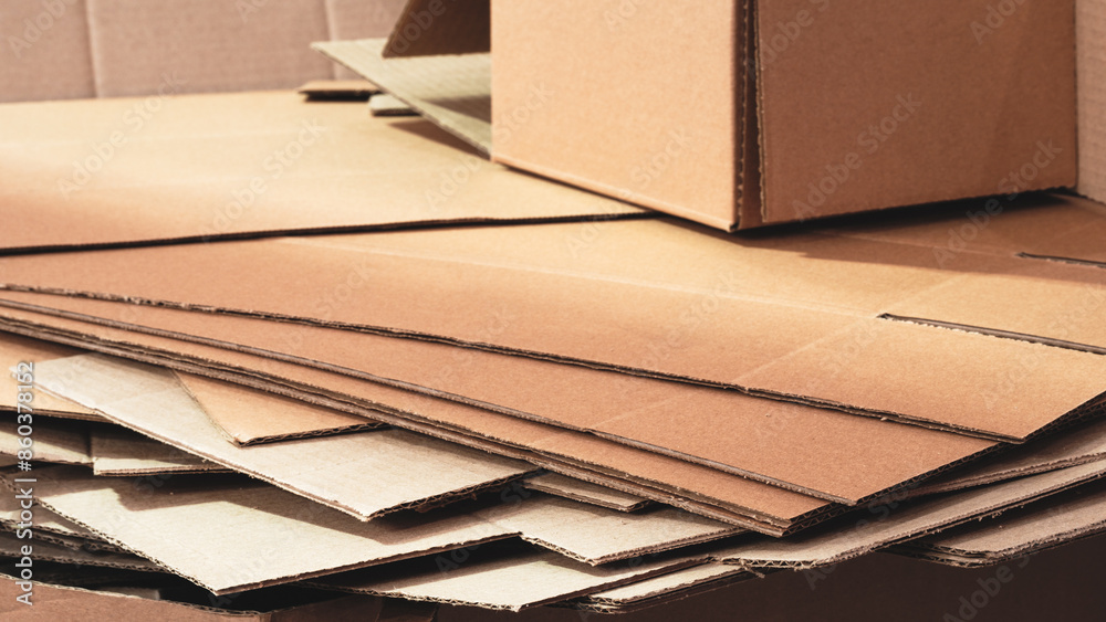Poster cardboard is neatly placed in a stack for further use