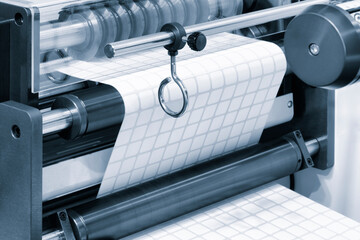 A roll of white paper is passed through the machine. printer and sticker machine, which is used for...