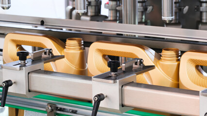 The machine produces plastic canister bottles for filling oil, paint and other chemical liquids