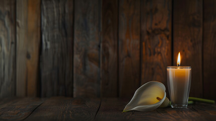 WHITE CALLA FLOWER NEXT TO A LIGHTED CANDLE ON WOODEN BACKGROUND CONDOLENCE CARD COPY SPACE : Generative AI