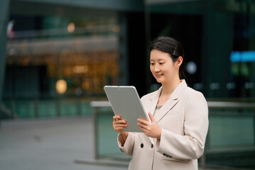 Businesswoman Using Tablet in Urban Setting