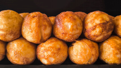 Takoyaki snacks on a black tray, Japanese style food