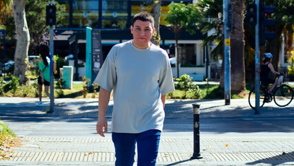 On the main road. young man crossing the street