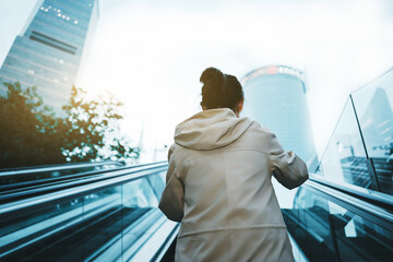 Urban Professional Ascending on Escalator