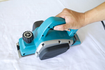 Naklejka premium Wood electric planer machine isolated on white background. An electric tool planer machine for wood. 