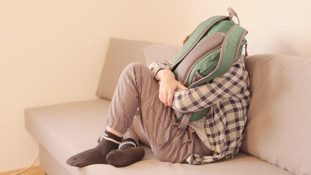 10-year-old boy in frustration on sofa, experiencing teenage angst and tantrums, coping with emotions, angst and frustration, mental health