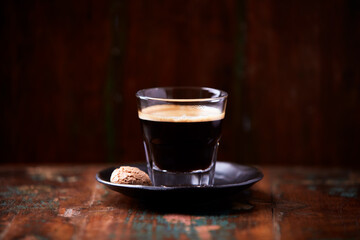 Coffee in glass cup on dark background. Close up. Copy space.