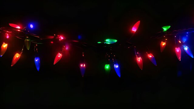 A string of Christmas lights with a black background