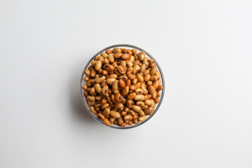 Fried soy bean on transparent glass bowl, isolated on white background, flat lay or top view