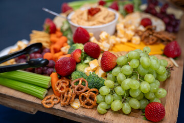 Graze Board. The Charcuterie board includes a variety of cheeses, fruits, vegetables, dips and crackers.