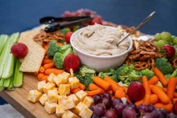 Graze Board. The board includes a variety of cheeses, fruits, vegetables, dips and crackers.