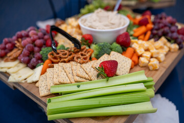 Graze Board. The board includes a variety of cheeses, fruits, vegetables, dips and crackers.