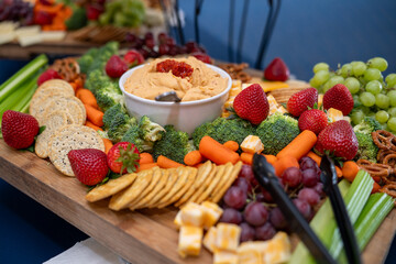 Graze Board. The board includes a variety of cheeses, fruits, vegetables, dips and crackers.