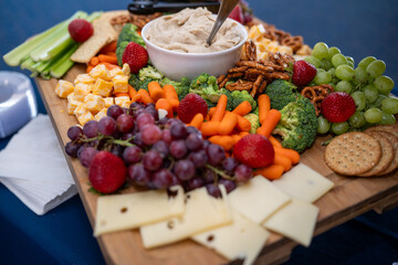 Graze Board. The board includes a variety of cheeses, fruits, vegetables, dips and crackers.