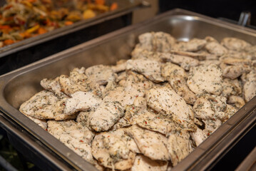 Herb garlic chicken, catered at an event. Chicken served in a warming tray. 