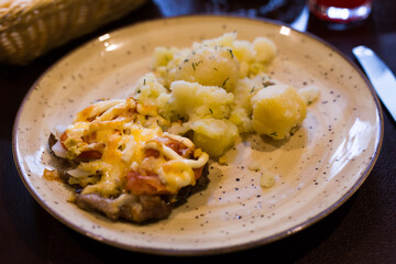 French meat with boiled potatoes served on plate