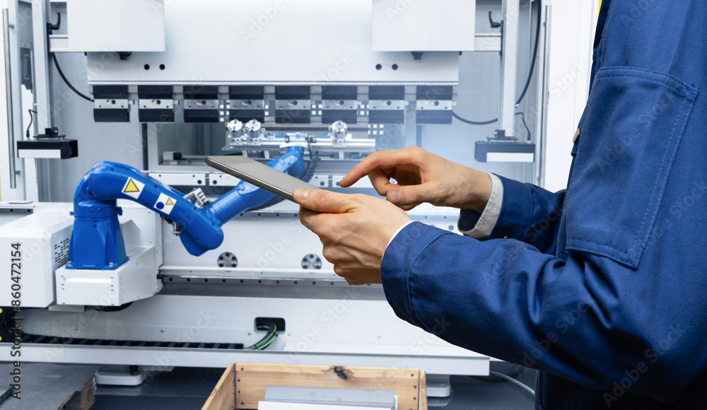 Fototapete engineer uses a digital tablet to control robots in a smart factory. smart industry 4.0 concept.