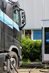 Zero emission 100% electric truck lorry plugged in on charge at a commercial charge station on an industrial estate
