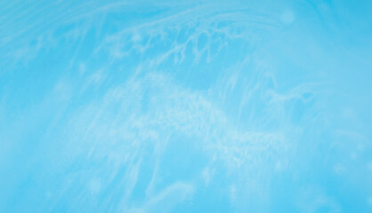 Naklejka premium abstract blue background with sun rays playing on the bottom of a blue pool.