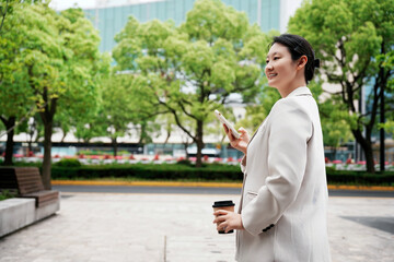 Confident Businesswoman Enjoying Coffee Outdoors