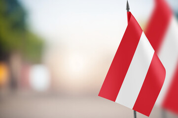 Small flags of Austria on a blurred background