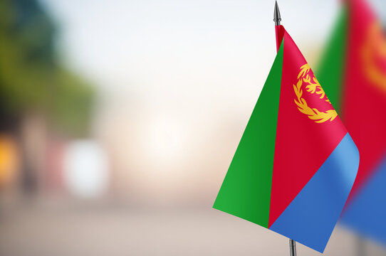 Small flags of Eritrea on a blurred background