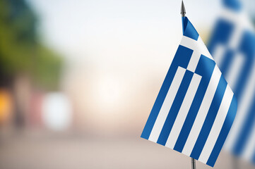 Small flags of Greece on a blurred background