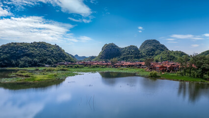 Fototapeta premium Serene Village Landscape by the Lake