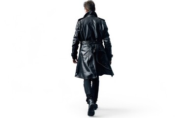 A person dressed in a black leather coat is walking