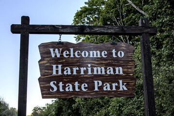 Welcome to Harriman State Park sign on Seven Lakes Drive at entrance to famous hiking destination.